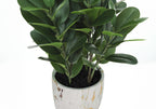 A medium-sized artificial Garcinia bush with dense green leaves in a white and gold marbled pot.