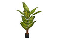 A tall artificial Dieffenbachia plant with broad, variegated green leaves in a simple black pot.