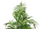Close-up of the feathery green fronds of a faux Areca palm tree against a plain white background.
