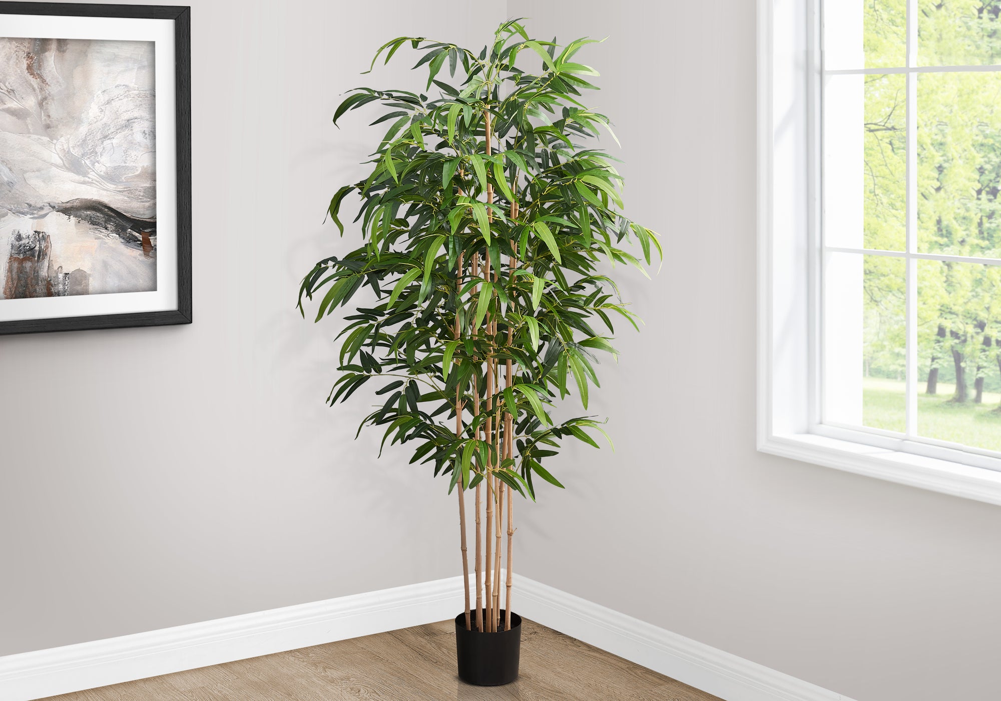 A tall artificial bamboo tree with slender stalks and lush green leaves standing in a corner next to a window.