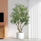 A tall artificial olive tree with green leaves and small black olives in a simple white cylindrical pot.