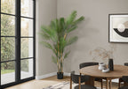 Large faux areca palm styled in a bright living room corner
