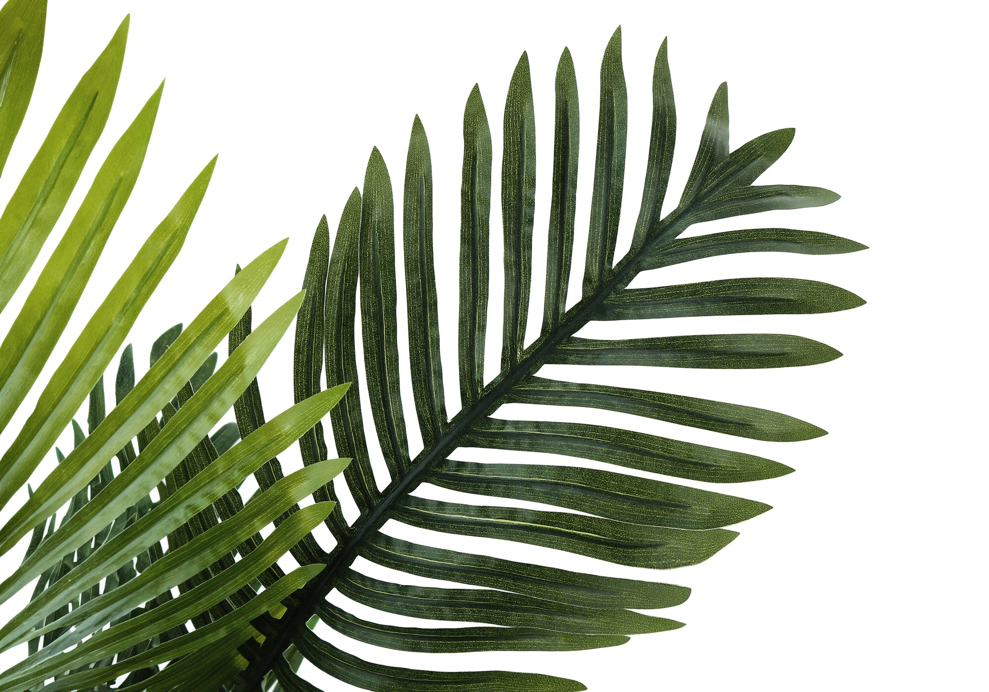 Close-up of the detailed green fronds of an artificial parlor palm plant against a white background.