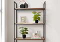 Two small artificial potted plants displayed on a modern metal and wood shelving unit with decor items.
