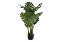 Large faux Monstera plant with split green leaves and tall stems in a black nursery pot