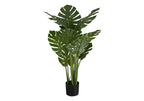 Large faux Monstera plant with split green leaves and tall stems in a black nursery pot