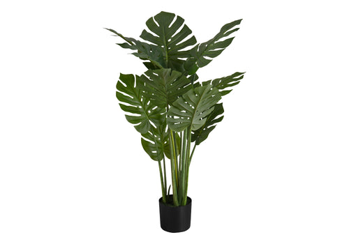 Large faux Monstera plant with split green leaves and tall stems in a black nursery pot