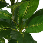 Close-up of the broad, green, and yellow patterned leaves of an artificial Dieffenbachia plant.