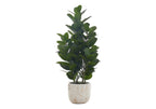 A medium-sized artificial Garcinia bush with dense, dark green leaves in a white and gold marbled planter.