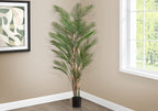 Tall artificial areca palm adding height and greenery to an indoor space