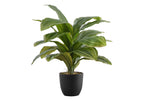Small faux Dracaena Lemon Lime plant with variegated green and yellow leaves in a simple black pot.