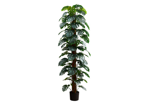 Tall artificial Monstera plant with numerous split leaves climbing a central moss pole in a black pot.