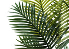Close-up of the lush, feathered green fronds of an artificial Majesty Palm tree against a white background.