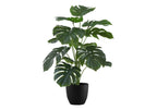 Artificial Medium Monstera plant with large, split green leaves in a black pot against a white background.