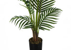 A tall artificial Majesty Palm tree with lush green fronds in a simple black pot against a white background.