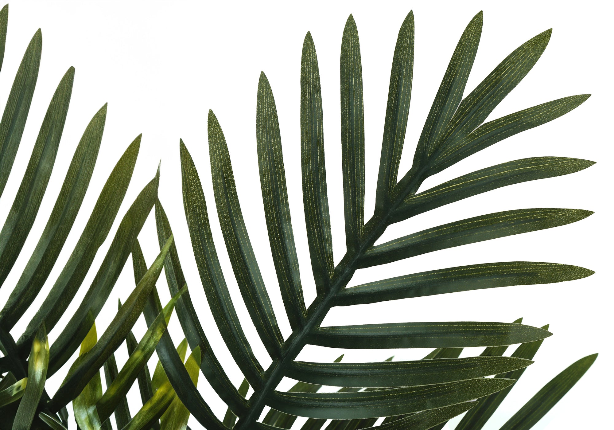Close-up of the green fronds of an artificial areca palm plant against a plain white background.