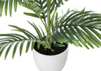 Close-up of a medium artificial Areca palm tree with green fronds planted in a simple white pot against white.