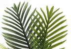 Close-up of two artificial Areca palm fronds with detailed green leaves against a plain white background.